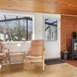 Room with seating, fireplace and window to outside.