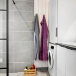 Bathroom with shower, washing machine, and sink