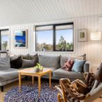 Living room with gray sofa, wooden table, and brown armchair.
