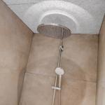 Shower with shower head and handheld shower on wall