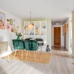 Living and dining area with fireplace, dining table, and seating.