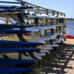 Surfboards on wooden racks by the beach