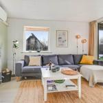 Living room with sofa, fireplace, and terrace