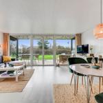 Living and dining area with view of garden and terrace.