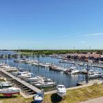 Harbor with boats and red houses by the coast.