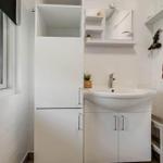 Bathroom with sink, mirror cabinet, and window
