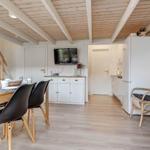 Kitchen and dining area with wooden ceiling and stairs to the ladder.