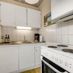 Kitchen with white cabinets, stove, and sink.