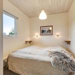 Bedroom with bed, window, and ceiling light.