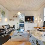 Living and dining area with sofa, TV, and dining table.