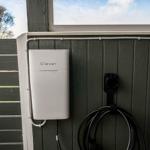 Charging station mounted on wall with coiled cable