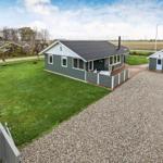 A house with garden and outbuilding. Lawn and gravel path.