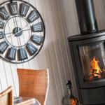 Living room with fireplace and wall clock with Roman numerals.