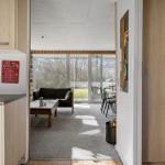 Kitchen with view of living and dining area with sofa and table.