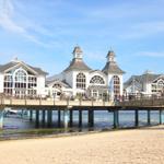 Hochgelegene Strandpromenade mit Restaurant und Aussichtsplattform über dem Wasser.