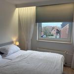 Schlafzimmer mit Doppelbett, Fenster und Heizkörper.