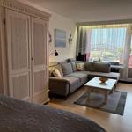 Wohnbereich mit Sofa, Couchtisch und Balkonansicht