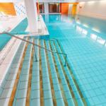 Innenpool mit Treppe und Liegewiesen