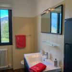 Bathroom with bathtub, mirror, and mountain view.