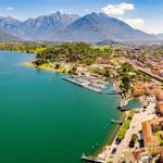 Town by lake with marina and mountains in background