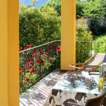 Terrace with table, chairs, and view of rose garden.