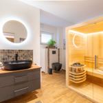 Bad mit Sauna, Waschbecken und Toilette.