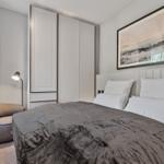 Bedroom with bed, wardrobe, and wall art.