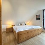 Bedroom with double bed, nightstand, and window with view.