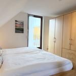 Bedroom with bed, wardrobe, and window to balcony.