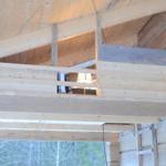 Wooden structure with bookshelf and lamp on upper level