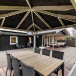 Terrace with seating group and dining table under roof