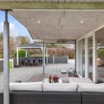 Terrace with seating area and gazebo. Glass doors and wooden decking.