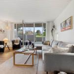 Living room with sofa, coffee table, and view of terrace