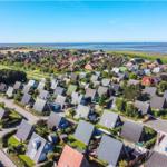 Aerial view of a residential area with many houses near the sea.