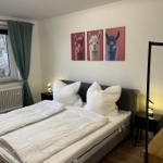 Schlafzimmer mit Doppelbett, Wandbildern und Fenster mit Blick.