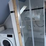 Bathroom with shower and washing machine