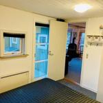 Bedroom with door to living area and small window.