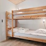 Room with wooden bed, window and wooden floor