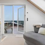 A living area with a view of a terrace with loungers.