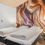 Room with double bed, wall mural, and window with view.