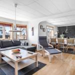 Living and dining area with sofa, dining table, and hardwood floor.