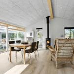 Dining area with table, chairs, and wood stove. Access to terrace and living area.
