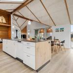 Kitchen with island, dining area, and view to terrace
