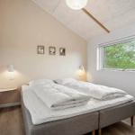 Bedroom with double bed, window, and wall lamps