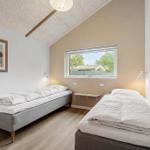 Two single beds, window with view, wall picture, wooden floor, ceiling light