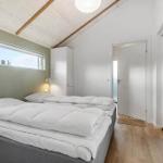 Bedroom with double bed, wooden floor, and large window. Door leads to balcony.