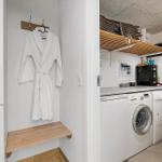 Laundry room with washer, dryer, and robe hanging on wall