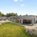 Modern villa with large garden and terrace. Glass facades and wooden cladding.