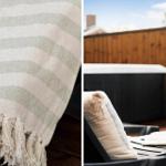 Strickdecke mit Fransen und Außenterrasse mit Liegestuhl und Whirlpool.