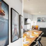 Dining room with wooden table and sofa. Wall art shows ships and platforms.